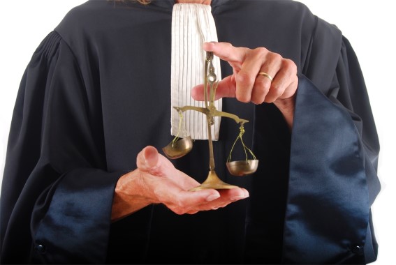 La justice illustrée par un homme tenant habillé en toge tenant une balance dans ses mains